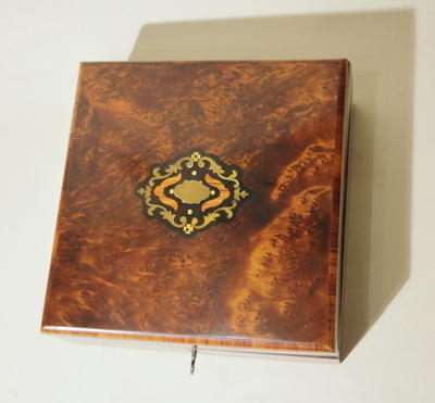 Шкатулка. Облицована корнем ореха, инкрустирована бронзой, чёрным и розовым деревом. Отделана шелаком.